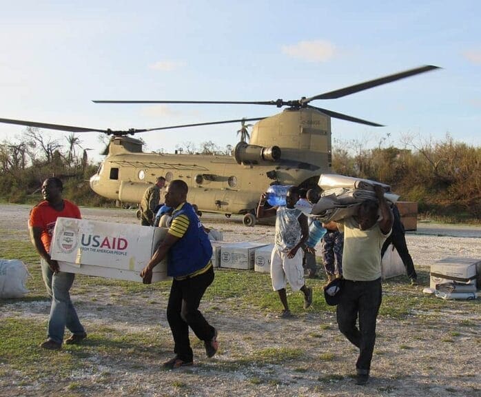 usaid workers haiti Foreign aid workers carry boxes marked with usaud from a helicopter in haiti