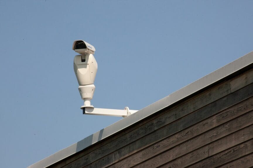 A security camera mounted on a roof in a police state