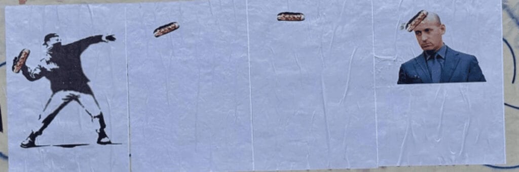 Banksy wall art of man throwing a sandwich at stephen miller