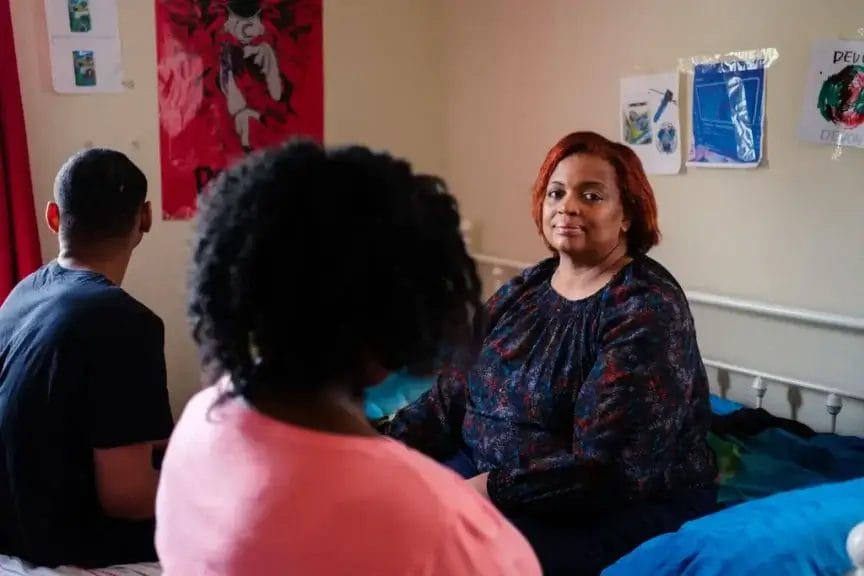 mother with children Mother sitting in the bedroom with teen kids