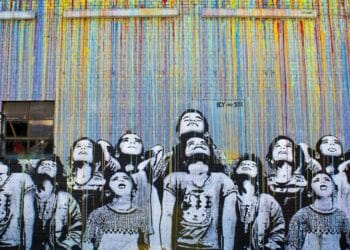 looking up Don't look up. Colorful fence with drawing of children all looking up.