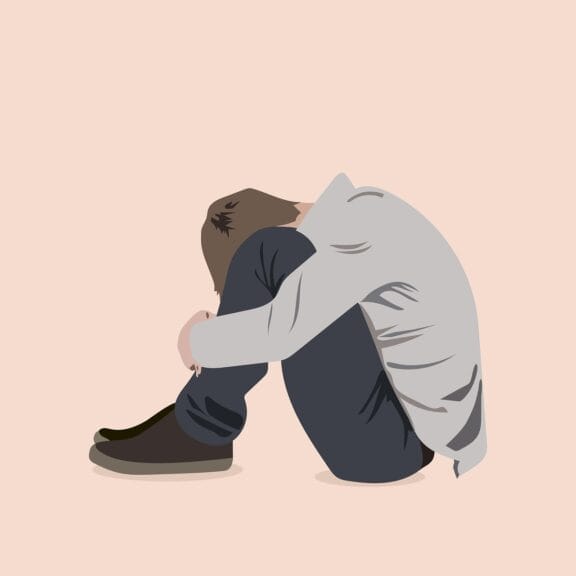 you are not alone Kgbtq mental health resources. Illustration if a young man sitting on the floor with his head between his knees
